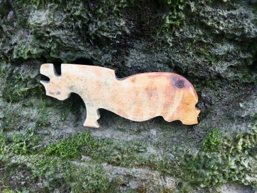 Rhinoceros. Cut out from stone, about two inches long.