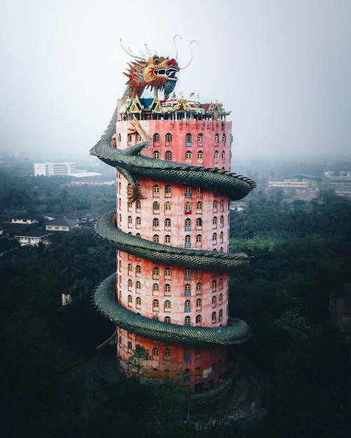 Wat Samphran, a Buddhist temple in Thailand. This 17-story building has a gigantic dragon sculpture 