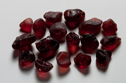 fuckyeahmineralogy:  Almandine, a type of garnet, in various stages of preparation.  Fully embedded in the matrix, as it would most commonly be found, and also jutting out of the matrix (I’m actually not sure if you find them like this, or if this