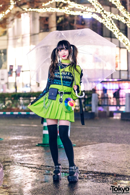 tokyo-fashion:  Japanese idol and Harajuku shop staff Misuru on the street in Harajuku in the rain wearing a neon one-armed jacket and skirt from WEGO with a lightning print top, Romantic Standard accessories, and Yosuke USA platform heels. Full Look