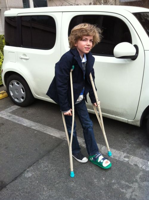 crutches, broken (or amputee) leg and converse sneakers