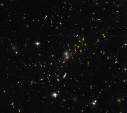 canadian-space-agency:  The mass of this galaxy cluster is approximately 180 TRILLION times the mass of the sun. Image credit: NASA