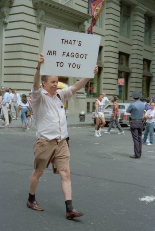 faghalforc:2othcentury:Pride, New York, June 1990 [id: a man walking in the street with a disgruntle