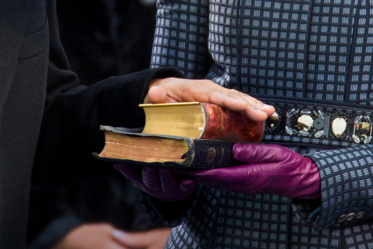 Time’s Best Photojournalism of 2013: U.S. President Barack Obama places his hand on two bibles as held by first lady Michelle Obama as his recites the oath of office during swearing-in ceremonies on the West front of the U.S Capitol in Washington....