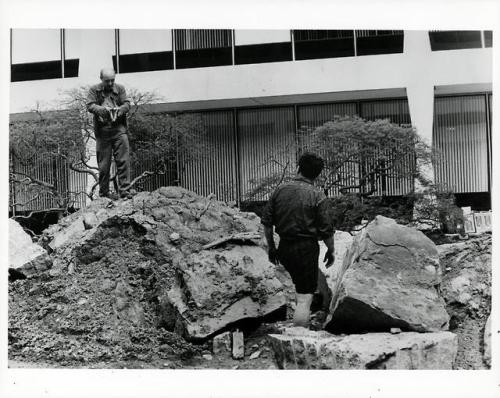(Above) Isamu Noguchi guiding the placement of elements in one of two gardens he designed for IBM He