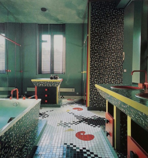 80sdeco:patterned laminate PoMo bathroom, mirrored cabinets, red fixtures, pixelated splatter tile f
