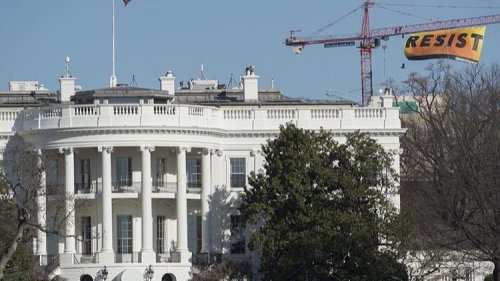 micdotcom:  Greenpeace protesters climbed a crane and unfurled a “resist” banner near White House