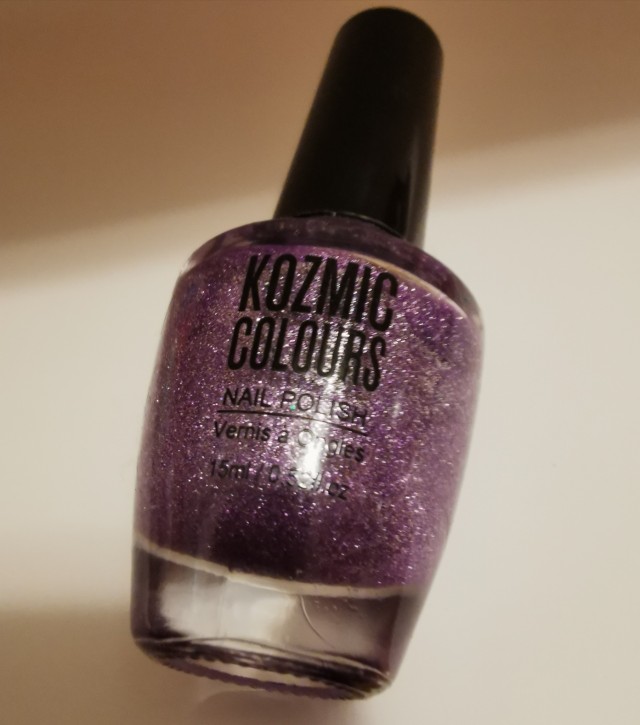 Bottle of nail polish used on the Pointer Finger: Kozmic Colours unidentified purple glitter 