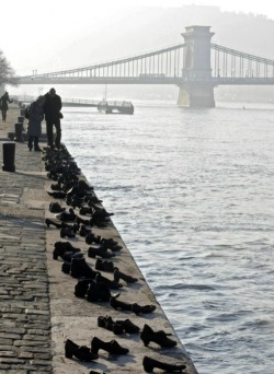 sixpenceee:  Iron shoes are pictured on the bank of the Danube on January 27, 2012, marking the Holocaust in Hungary. Hundreds of Hungarian Jews had to leave their shoes on the bank before they were shot into the river by Hungarian militaimen during the