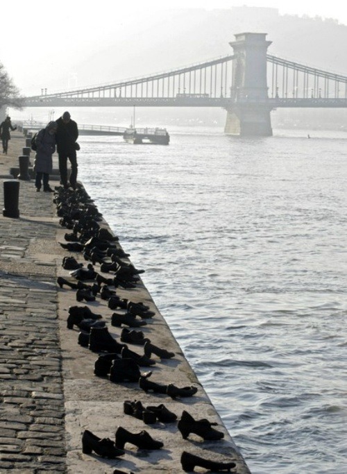 sixpenceee:Iron shoes are pictured on the bank of the Danube on January 27, 2012, marking the Holoca