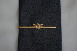 otlgaming:  GAMER TIE CLIPS Many of us work jobs that frown upon flaunting our gamertude and we have to be careful about what we wear and accessorize with. So when a design comes along that lets us display our geekiness subtly and in a way that won’t