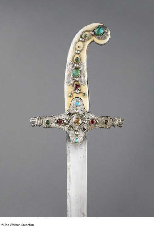 Ornate sabre decorated with gold, silver, ivory, and colored gems. Blade was produced in 16th centur