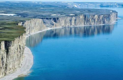 Akpatok IslandWithin the frigid confines of the Canadian Arctic, Akpatok Island ascends from the sea