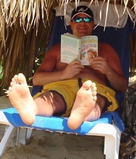 Dad found a shady spot to relax and read.