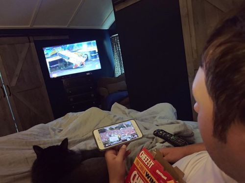 The formula for a perfect Saturday morning: staying in bed + husband + cat + BattleBots + College Ga