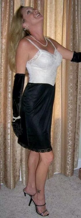 Interesting combination of lingerie here - it looks like she’s wearing black half slip with a 