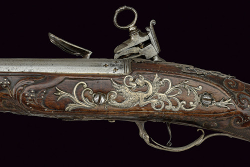 Ornate miquelet musket with silver mounted carved stock.  Originates from Italy, early 19th century.