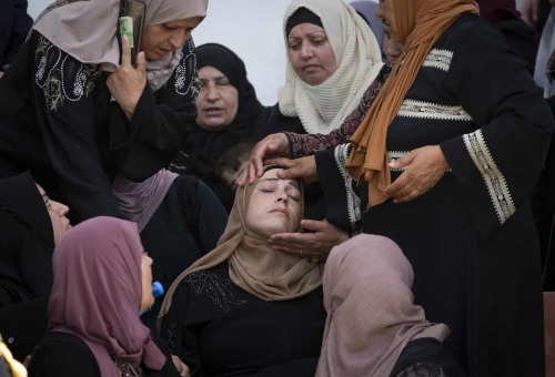 Women mourn during the funeral of a Palestinian security officer, Tayseer Issa, in the West Bank cit