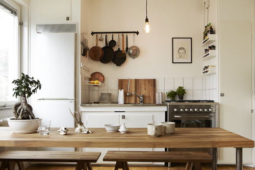 Captivating Kitchen The warm hues of the wooden furniture and muted filament light help soften this 