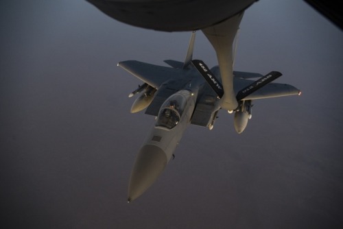 retrowar:  A U.S. F-15C Eagle approaches the boom of a 28th Expeditionary Air Refueling Squadron KC-135 Stratotanker during a combat air patrol mission over an undisclosed location in Southwest Asia, Sept. 18, 2019.  (U.S. Air Force photo by Master Sgt.