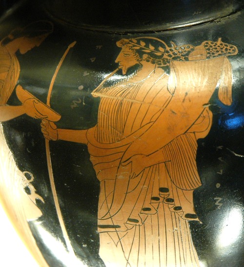 Hades holding a cornucopia, evoking his alternate persona of Plouton (Pluto), god of wealth and guar