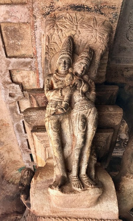 Amorous couple on pillar top looking below in Cave 3, Badami Hindu cave temple in Karnataka, India; 
