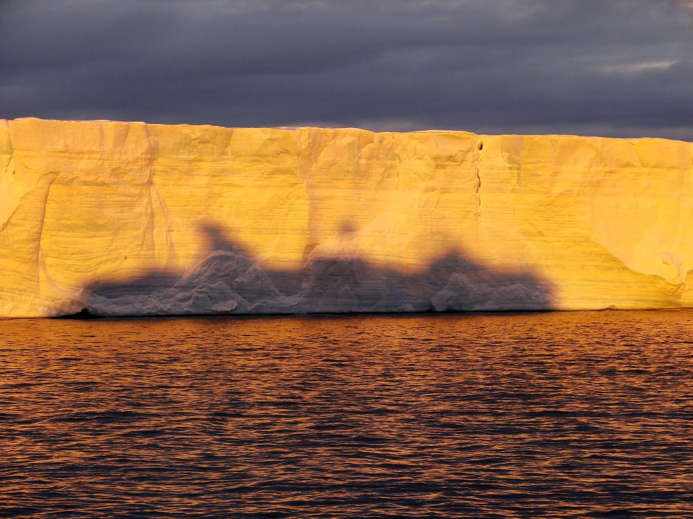 uemou:  Sunset shadow of ship on huge tabular berg by ericy202