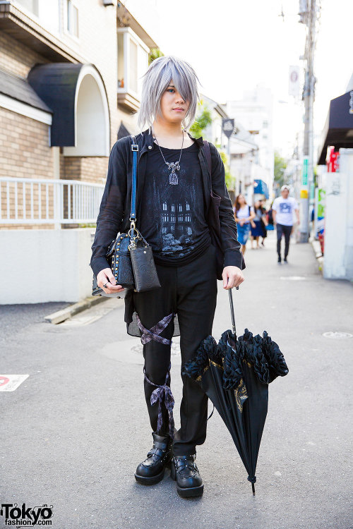 22-year-old Pokki on the street in Harajuku wearing an all black outfit featuring a Laurant jacket a