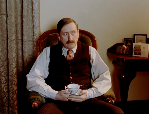 Inspector Japp drinks tea and suffers through carol singing (Hercule Poirot’s Christmas)