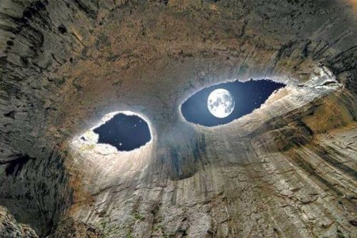 meditationtemptation:“The Eyes of God” -Prohodna Cave, Bulgaria (Source, I believe) This is the full moon from inside a cave. It looks like two eyes staring down at you; beautiful.   O oO 