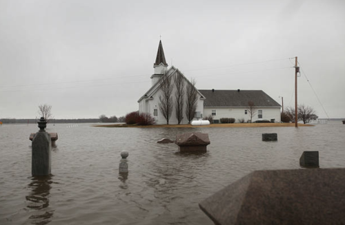 A rural church is surrounded by flood water, April 10, 2011, near Gardner, North Dakota.&gt; Photos: