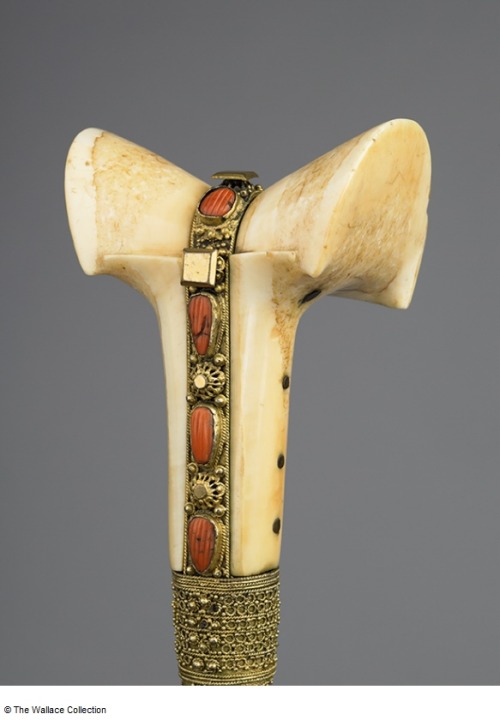 Ornate yatagan with walrus ivory hilt mounted with gold, silver, and red coral. Originates from the 