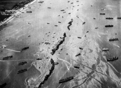 georgy-konstantinovich-zhukov:“Thirteen liberty ships, deliberately scuttled to form a breakwater for invasion vessels landing on the Normandy beachhead lie in line off the beach, shielding the ships in shore. The artificial harbor installation was