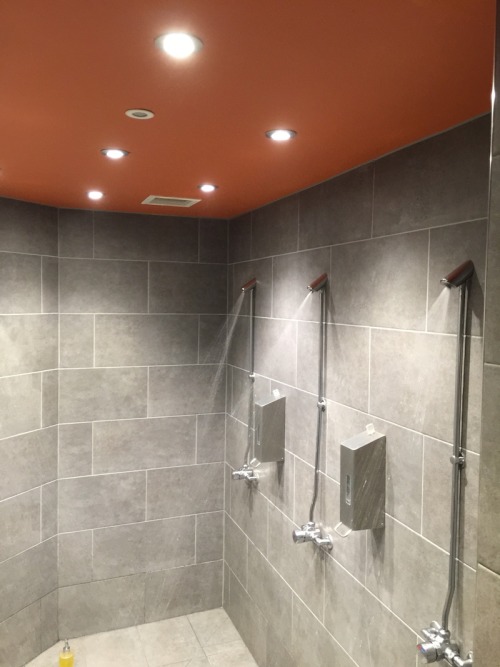 Men’s shower room at Bikram Yoga, Canary Wharf, London, UK.These showers were renovated in 2018. It’