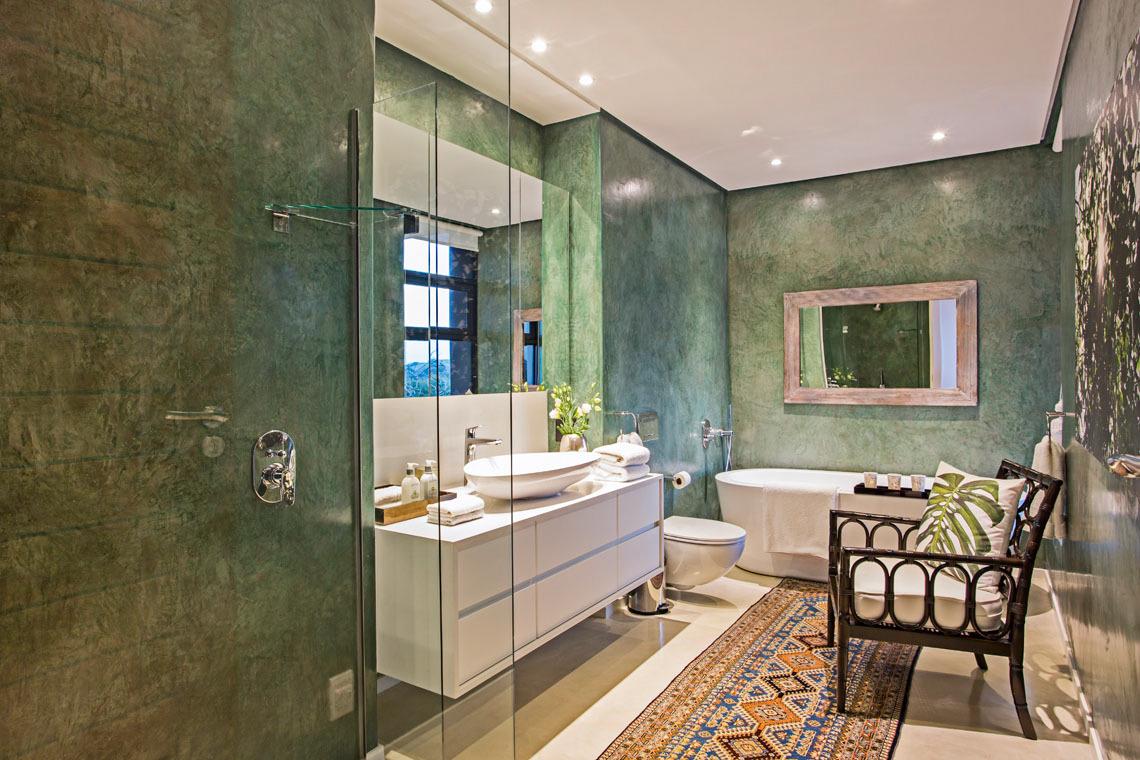 homestratosphere:  A smaller, modern, master bathroom with textured walls and white