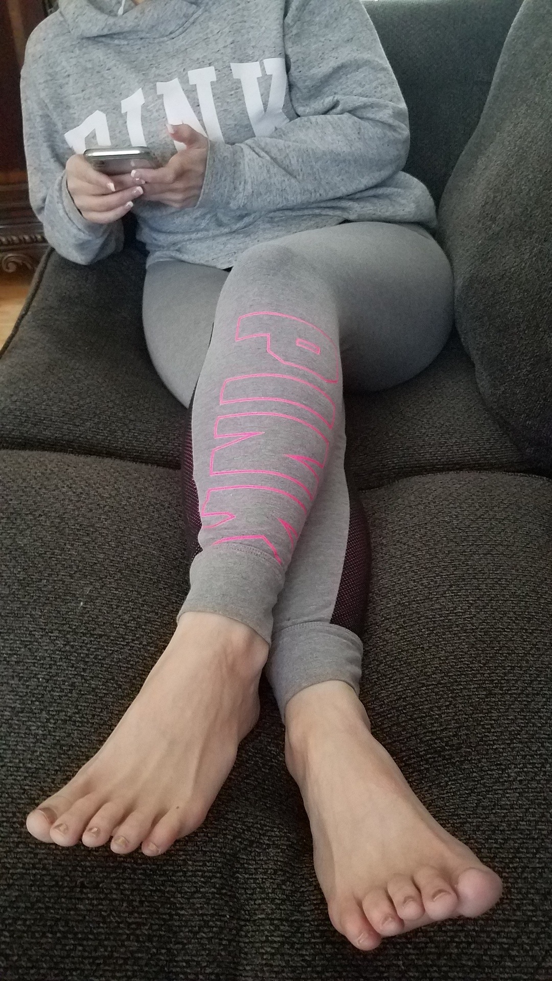 myprettywifesfeet:My pretty wife looking cute on the couch with her phone and her