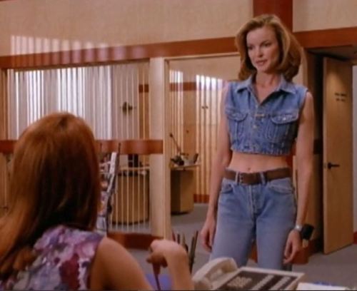 Kimberly wears a sleeveless denim crop top with mom jeans. Sexy!  (She actually looks surprisin