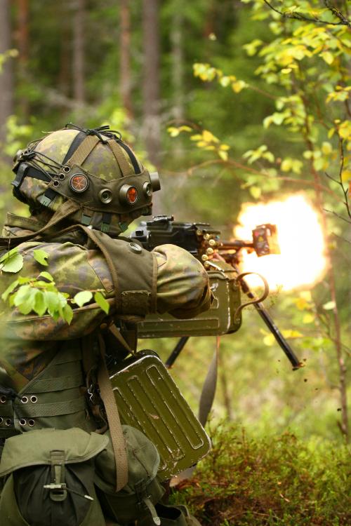 militaryarmament:A Finnish Army soldier letting loose his PKM machine gun on “opposing forces” durin