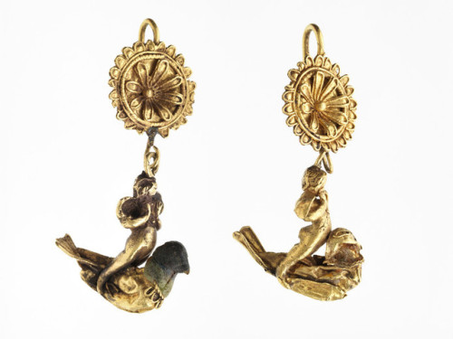theancientwayoflife:~ Pair of earrings with Eros riding a dove.Place of origin: GreekDate: 299-200 B