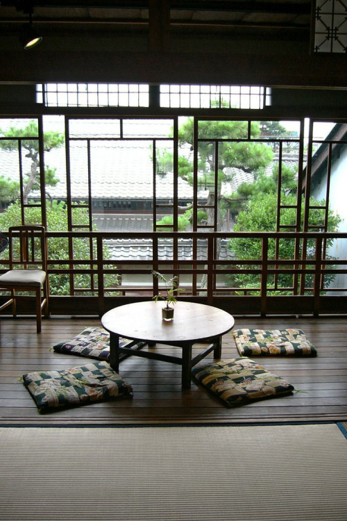 A chabudai (Japanese low dining table with short legs) in a traditional setting. People seated at a 