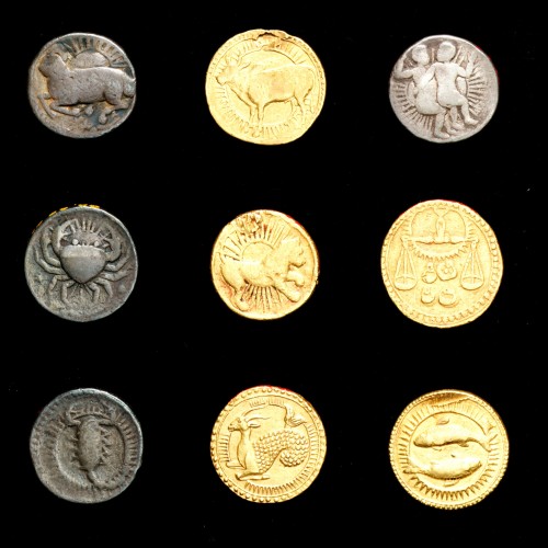 Coins with symbols of the zodiac, an idea the emperor recorded in his journals.    Minted in India d