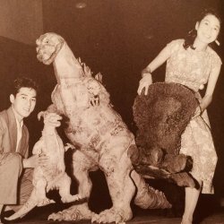 jimpluff:  Akira Takarada plays with Godzillas. Momoko Kouchi tries on big Godzilla foot. [x]