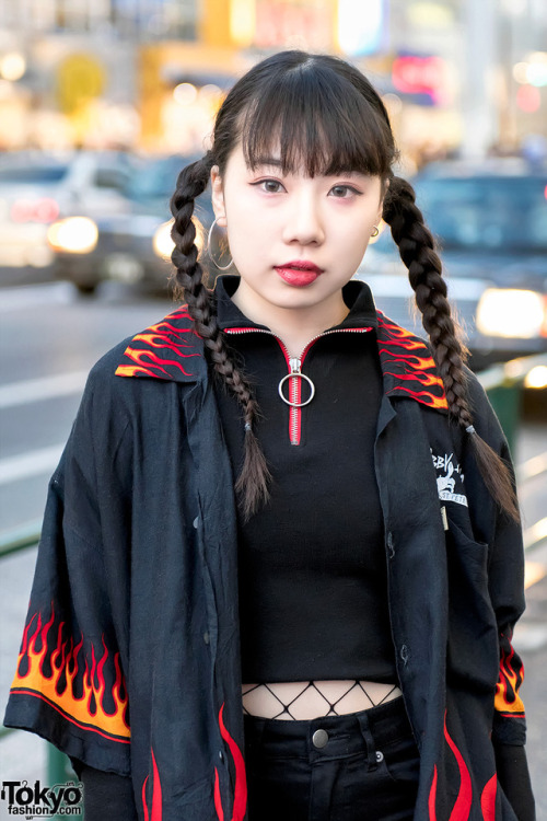 tokyo-fashion:16-year-old Beni on the street in Harajuku wearing a resale oversized flame shirt over a crop top from Never Mind the XU Harajuku, resale shorts with fishnets, creepers, a WEGO bag, and accessories by the Korean streetwear brand More Than