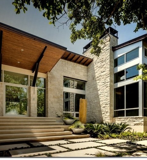 Stone Exterior In Austina Large, Modern, Two-story Beige Stone Home With A Shed Roof.