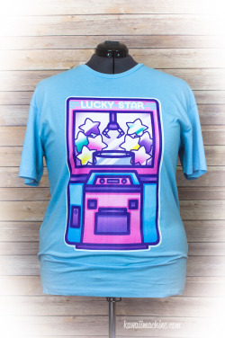 thekawaiimachine:  The Lucky Star UFO Catcher tee is now available in the shop!  I’m hopelessly addicted to claw machines, so I was really excited to make this design &lt;3.  As always, these are available on women’s classic tees in size S through