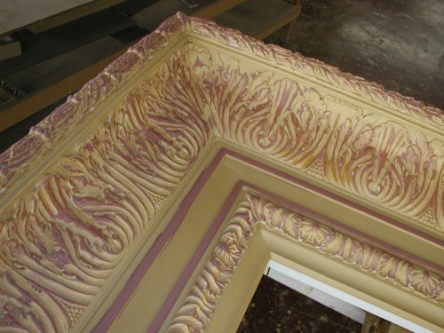 This reproduction of a 19th century frame was carved entirely by hand. The moulding is 12 inches wide and is finished in 22k gold leaf over yellow clay with red highlights. The pictures above show some of the steps during production.