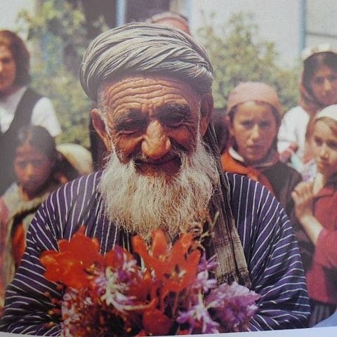 faromush:Elderly Tajik man holding flowers.