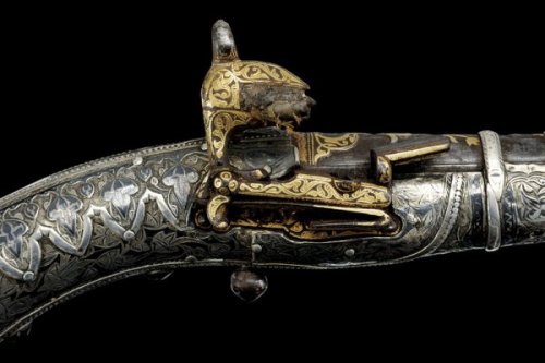 A finely engraved gold and silver decorated Cossack&rsquo;s pistol, early 19th century.Estimated Val