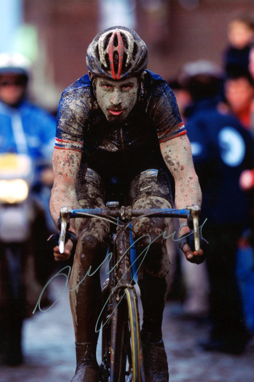 George Hincapie racing a muddy Paris-Roubaix.