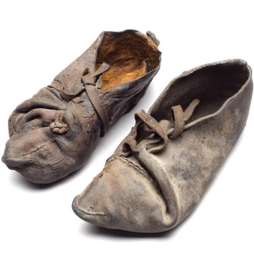 irisharchaeology:A pair of cowhide shoes. Found with a Danish bog body they date from c. 355-47 BCSo